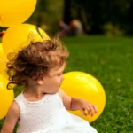 Child playing on a clean grassy yard after pet waste removal service
